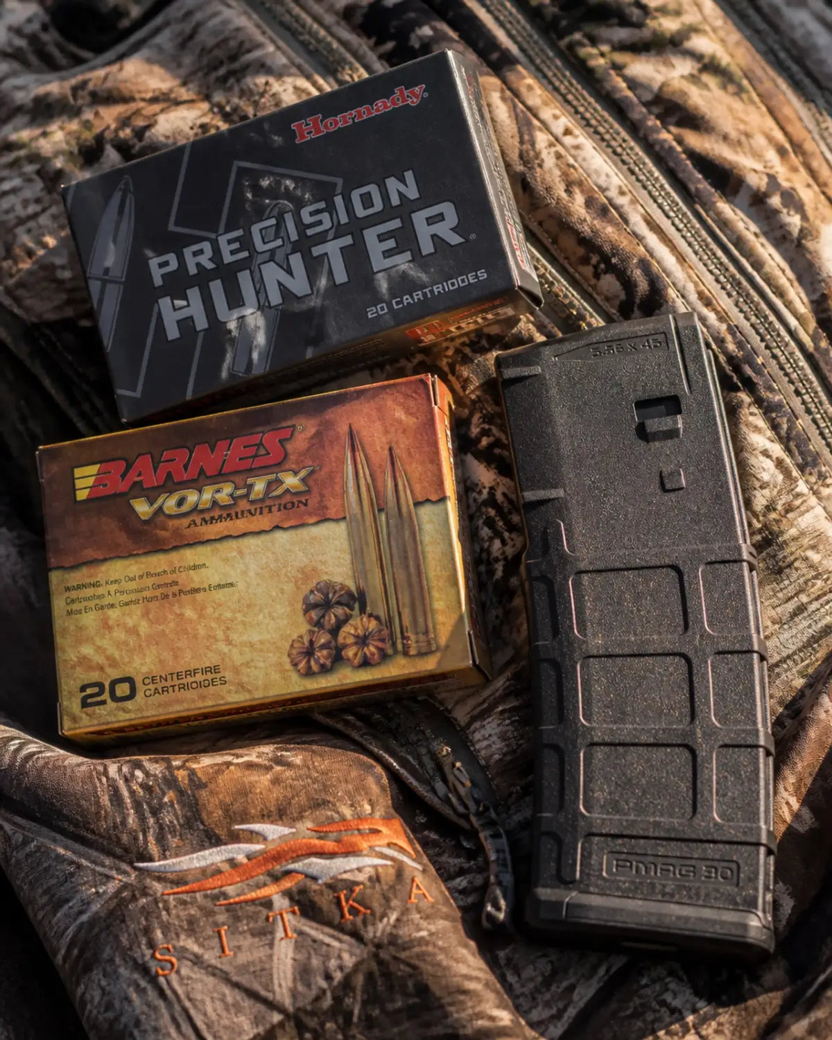 Premium ammunition and Magpul gear on a camouflage jacket