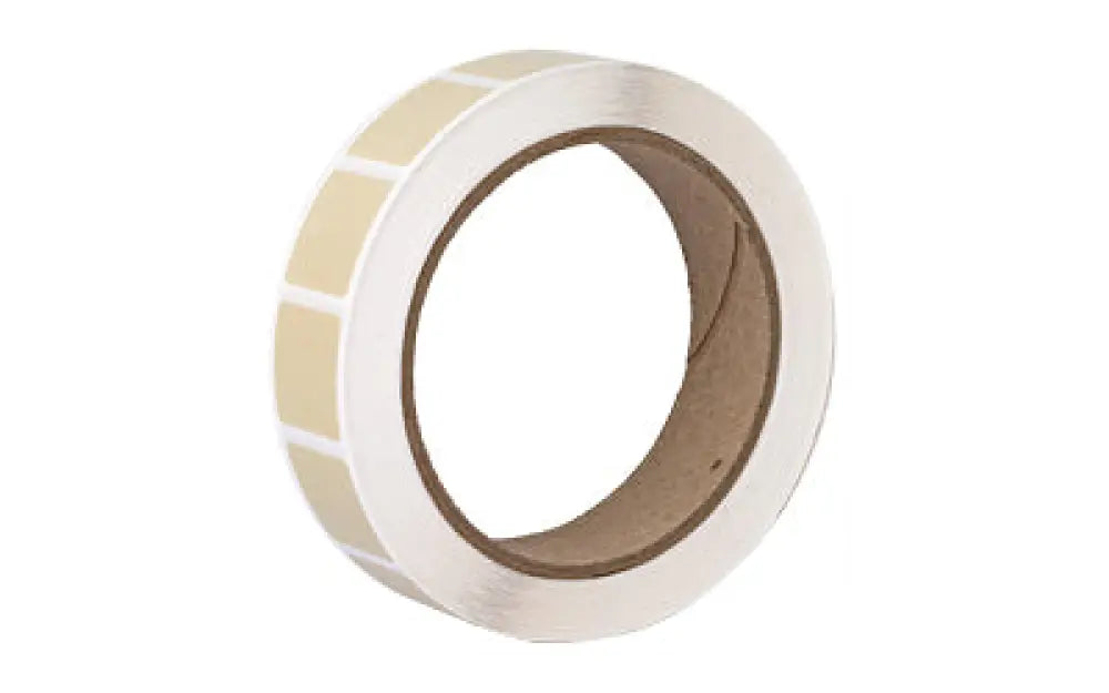 Roll of Action Target Past Buff pasters, beige labels on core