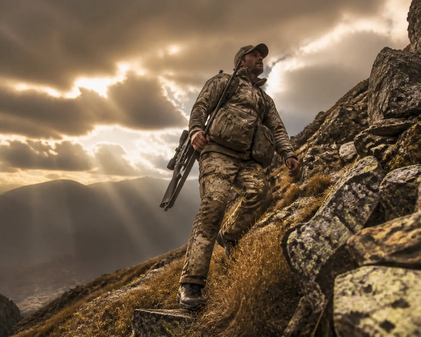 Hunter on a rugged ridge under dramatic skies, illustrating faith-fueled courage in the wild.